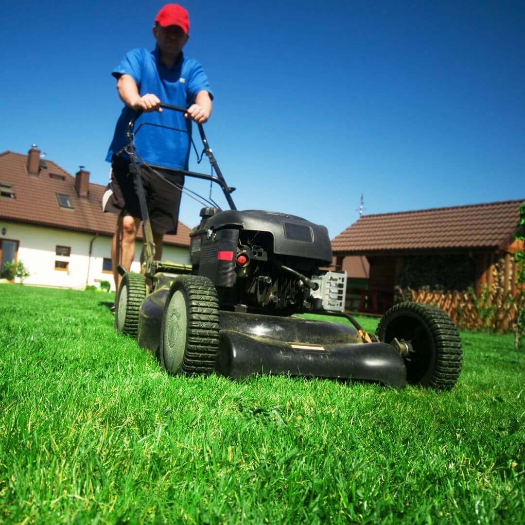 man pushing lawnmower